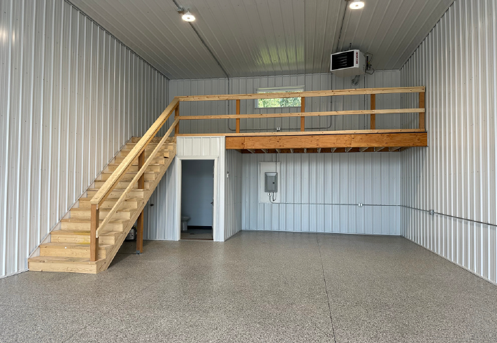 yankton 3 Empty garage with wooden loft and stairs.