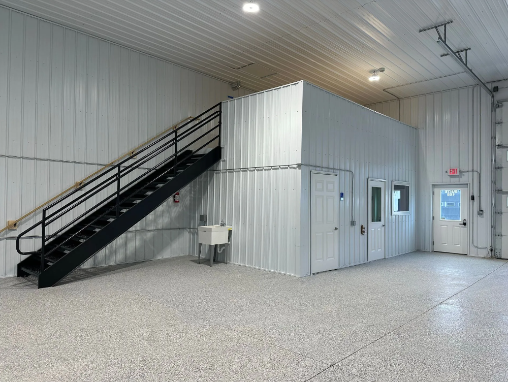 Industrial interior with stairs and small office cabin.