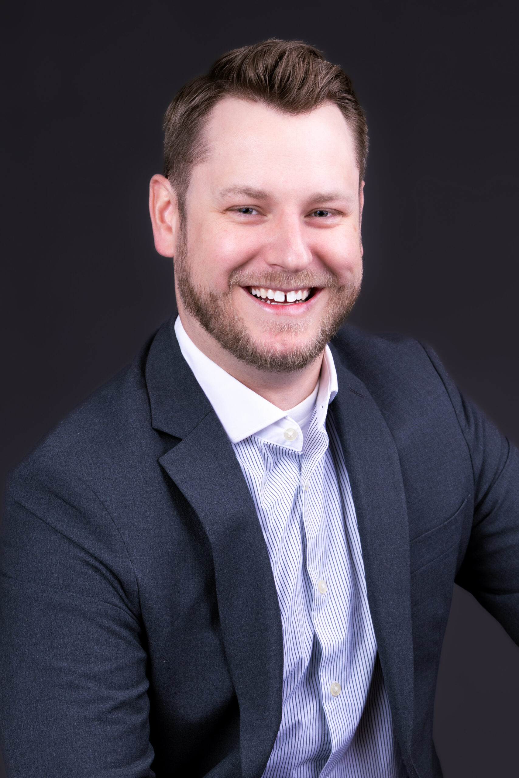 Man smiling in a suit and shirt